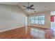 Bright living room boasts hardwood floors, a ceiling fan, and large windows, creating an airy and welcoming atmosphere at 1436 Harbor Mist Ct, Charleston, SC 29492