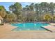 A large community pool featuring a zero entry and splash pad area with a forest of trees in the background at 1436 Harbor Mist Ct, Charleston, SC 29492
