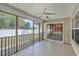 Comfortable screened-in porch with tile floor, ceiling fan, and slider to interior at 1436 Harbor Mist Ct, Charleston, SC 29492