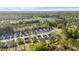 An aerial view of a suburban neighborhood showcasing modern homes, green spaces, and a tranquil pond at 149 Caleb Ct, Ladson, SC 29456