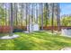 Well-manicured backyard with shed, garden, and mature trees creating a private oasis at 149 Caleb Ct, Ladson, SC 29456