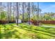 Backyard with shed, above-ground pool, and manicured lawn surrounded by tall pines at 149 Caleb Ct, Ladson, SC 29456