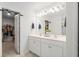 Bathroom featuring a double vanity with modern fixtures and a view into the walk-in closet at 149 Caleb Ct, Ladson, SC 29456