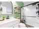 Stylish bathroom featuring modern vanity, glass-enclosed shower, and charming wooden wall shelves at 149 Caleb Ct, Ladson, SC 29456