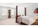 Spacious bedroom with four-poster bed, vintage grandfather clock, and neutral walls at 149 Caleb Ct, Ladson, SC 29456