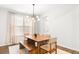 Bright dining room with modern chandelier, natural light, stylish curtains and a cozy bench at 149 Caleb Ct, Ladson, SC 29456