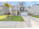 Attractive two-story home with a well-maintained lawn, a palm tree, and a welcoming front porch area at 149 Caleb Ct, Ladson, SC 29456