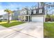 Lovely two-story home featuring a well-kept lawn, a palm tree, and a welcoming front porch at 149 Caleb Ct, Ladson, SC 29456