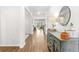 Inviting hallway featuring hardwood floors, stylish furniture and decor, and leading to a bright backyard view at 149 Caleb Ct, Ladson, SC 29456
