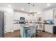 Bright kitchen features white cabinets, stainless steel appliances, granite countertops, and an island with barstool seating at 149 Caleb Ct, Ladson, SC 29456