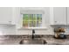 Bright kitchen features granite countertops, white subway tile backsplash, and stainless steel faucet near a window at 149 Caleb Ct, Ladson, SC 29456