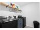 Well-organized laundry room with modern washer and dryer, stylish shelf, countertop, and storage at 149 Caleb Ct, Ladson, SC 29456
