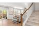 Bright living room with access to the porch featuring hardwood floors, staircase, and neutral decor at 149 Caleb Ct, Ladson, SC 29456