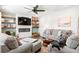 Relaxing living room featuring fireplace, ceiling fan, comfortable seating, and decorative built-in shelves at 149 Caleb Ct, Ladson, SC 29456