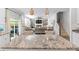 Granite kitchen island with barstool seating offers seamless flow to the living area with stairs in view at 149 Caleb Ct, Ladson, SC 29456