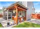 Covered outdoor kitchen and dining area with adjacent screened-in porch at 149 Caleb Ct, Ladson, SC 29456