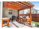 Covered outdoor kitchen with wood pergola, built-in grill and countertops at 149 Caleb Ct, Ladson, SC 29456