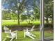 Inviting backyard view with Adirondack chairs and lush greenery, perfect for relaxation at 1603 Ventura Pl, Mount Pleasant, SC 29464