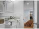 Clean bathroom with a marble countertop, white cabinets, and doorway view to hallway at 1603 Ventura Pl, Mount Pleasant, SC 29464