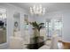 Elegant dining room featuring hardwood floors, large windows, and a modern crystal chandelier at 1603 Ventura Pl, Mount Pleasant, SC 29464