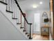 Elegant foyer with hardwood floors, staircase and a stylish table at 1603 Ventura Pl, Mount Pleasant, SC 29464