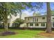 Exterior shot of a townhome with a private backyard, mature trees, and lush lawn at 1603 Ventura Pl, Mount Pleasant, SC 29464