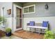 Inviting front porch featuring a cozy bench with decorative pillows and a welcoming welcome mat at 1603 Ventura Pl, Mount Pleasant, SC 29464