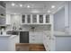 Bright kitchen with white cabinets, stainless steel sink, and marble backsplash at 1603 Ventura Pl, Mount Pleasant, SC 29464
