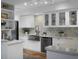 Modern kitchen with white cabinets, stainless steel sink, and marble backsplash at 1603 Ventura Pl, Mount Pleasant, SC 29464