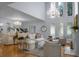 Large living room with high ceilings, two chandeliers, and hardwood floors at 1603 Ventura Pl, Mount Pleasant, SC 29464