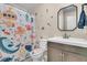 Charming bathroom featuring colorful sea-themed shower curtain and decor at 1628 Point Park Dr, Johns Island, SC 29455