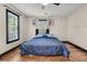 Bright bedroom features hardwood floors, large windows, and ceiling fan at 1628 Point Park Dr, Johns Island, SC 29455