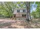 Charming two-story home with a welcoming front porch and lush, mature trees surrounding the property at 1628 Point Park Dr, Johns Island, SC 29455