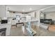 Bright, modern kitchen features white cabinets, countertops, and stainless steel appliances with an open layout to the living area at 1628 Point Park Dr, Johns Island, SC 29455