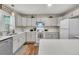 Bright kitchen with white cabinets, sleek countertops, and stainless steel dishwasher for a modern cooking experience at 1628 Point Park Dr, Johns Island, SC 29455