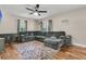 Comfortable living room features a sectional sofa, warm wood floors, and a ceiling fan for a relaxing atmosphere at 1628 Point Park Dr, Johns Island, SC 29455