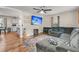Cozy living room with hardwood floors, a large sectional sofa, and a modern ceiling fan for comfortable living at 1628 Point Park Dr, Johns Island, SC 29455