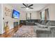 Inviting living room with a large sectional sofa, stylish area rug, and a wall-mounted TV for entertainment at 1628 Point Park Dr, Johns Island, SC 29455