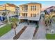 Aerial view of coastal home with covered parking, dual balconies, and pretty palm tree landscaping at 1681 E Ashley Ave # A, Folly Beach, SC 29439