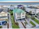 Aerial of beautiful beach neighborhood home with a green roof and multiple balconies at 1681 E Ashley Ave # A, Folly Beach, SC 29439