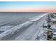 Beautiful aerial view of the beach meeting the ocean, showing the shoreline and ocean homes at sunset, for a tranquil vibe at 1681 E Ashley Ave # A, Folly Beach, SC 29439