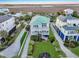 Low aerial view of beautifully landscaped home with green roof, dual balconies and neighborhood at 1681 E Ashley Ave # A, Folly Beach, SC 29439