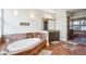 Bathroom featuring a soaking tub, tiled accents and a walk-in shower at 1681 E Ashley Ave # A, Folly Beach, SC 29439