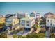 Beautiful beachfront homes with decks overlooking the ocean on a sunny day at 1681 E Ashley Ave # A, Folly Beach, SC 29439