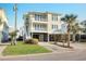 Stunning three-story home featuring dual balconies, a two-car garage, and lush landscaping at 1681 E Ashley Ave # A, Folly Beach, SC 29439