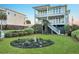 Landscaped front yard with lush grass, manicured bushes, and a charming flower garden, enhancing the home's curb appeal at 1681 E Ashley Ave # A, Folly Beach, SC 29439