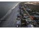 Scenic aerial shot of beach houses near the ocean and adjacent to a road at 1681 E Ashley Ave # B, Folly Beach, SC 29439