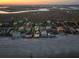 An aerial view shows waterfront homes at dusk near a marshy inlet at 1681 E Ashley Ave # B, Folly Beach, SC 29439