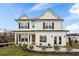 Beautiful two-story home featuring a classic design, black shutters, a welcoming porch, and landscaping at 177 Cantona Dr, Summerville, SC 29483