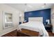Spacious bedroom featuring a blue accent wall, hardwood floors, and ample natural light at 1812 Overrun St, Charleston, SC 29414